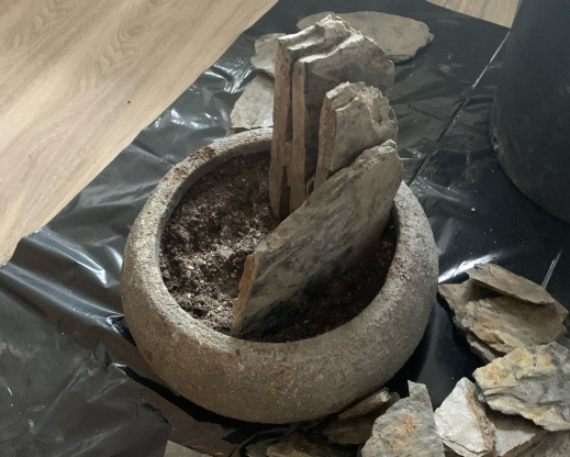 The process of building a crevice garden in a  container.