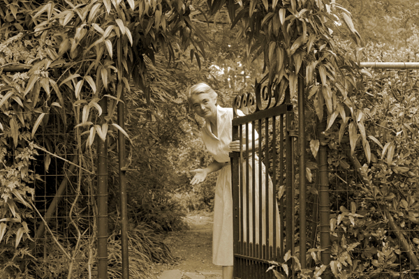 Elizabeth Lawrence at her garden gate, August 1957. Photo courtesy the Charlotte Observer collection.