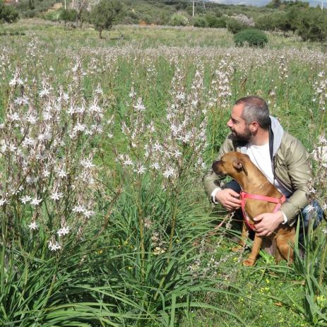 Dariotis admiring wild flowers with a canine companion
