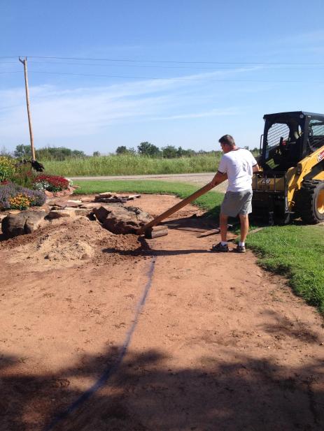 Using a wooden lever to shift rocks into place.