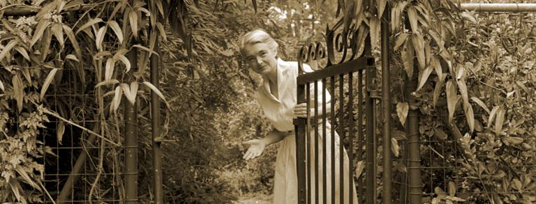 Elizabeth Lawrence at her garden gate, August 1957. Photo courtesy the Charlotte Observer collection.